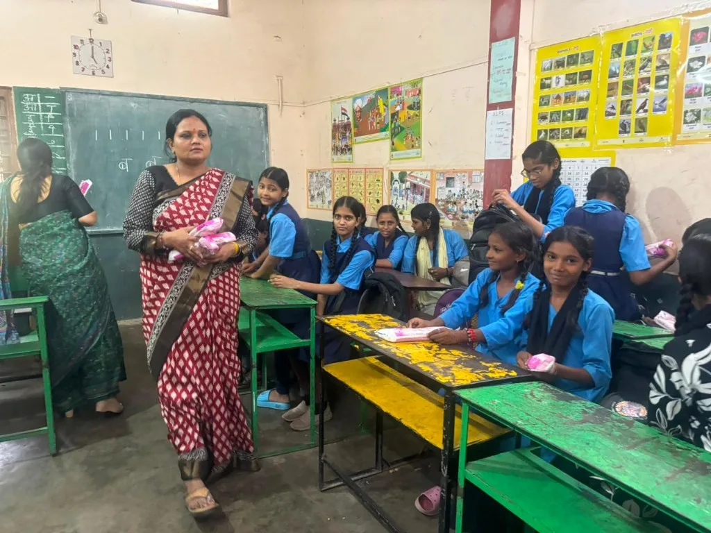 SAANJ distributing hygiene support to schoolgirls in a classroom program